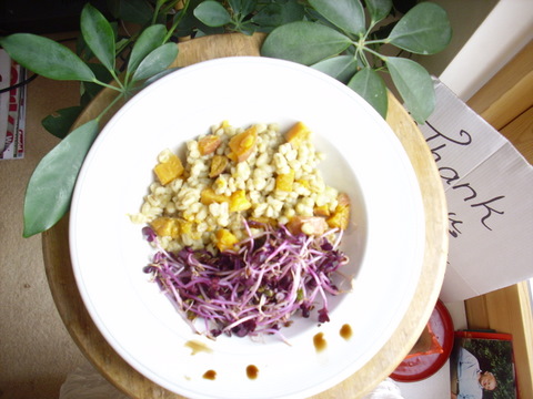 Barley and purple sprouts in white bowl, photo in very far corner