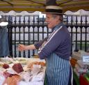 David Felce, the fishmonger, sleeves rolled up, with fish stall