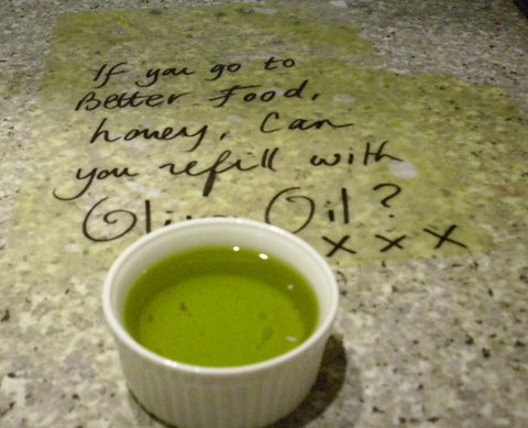Spilt olive oil and reminder note to buy more