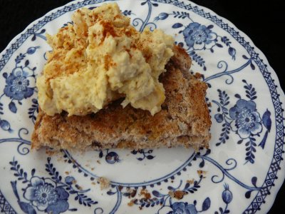 A blog of hummous on toast made with spelt on a plate
