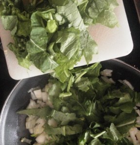 Cut-up turnip tops and into the pan they go