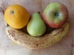 Apple, orange and pear in the curve of banana's