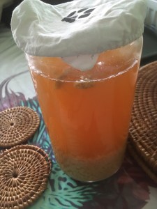 A large jar of translucent ginger beer