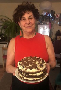 The blog author holding the assembled four layered black ofrest gateau